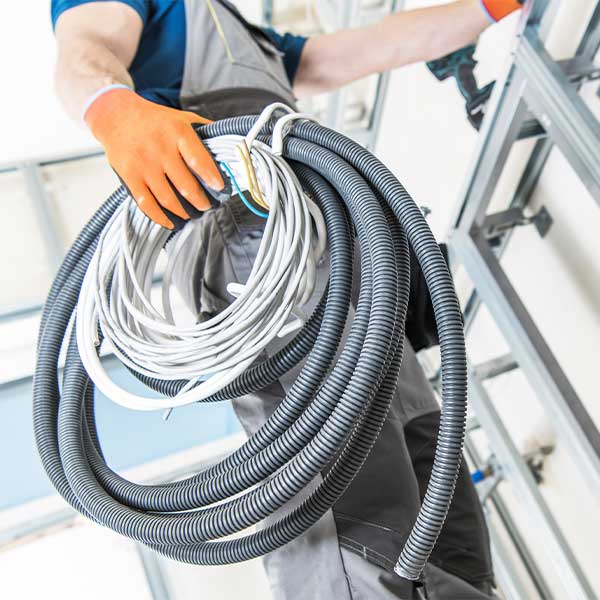 Worker holding electrical equipment