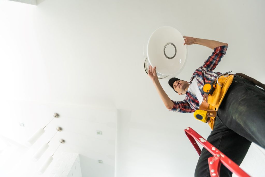 Electrician installing energy-efficient LED lighting in a residential property