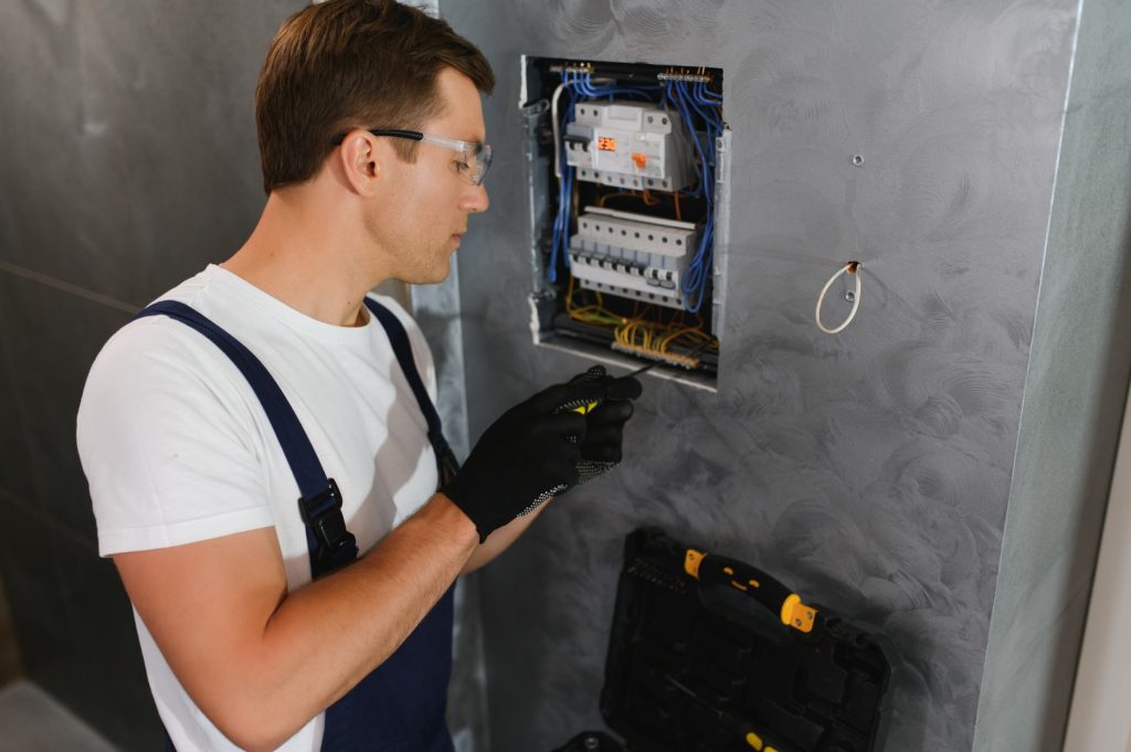 Experienced electrician repairing a circuit breaker