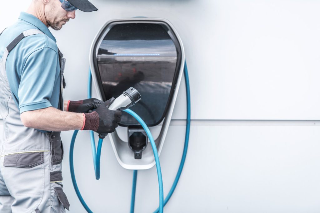 The technician is installing an EV charging station
